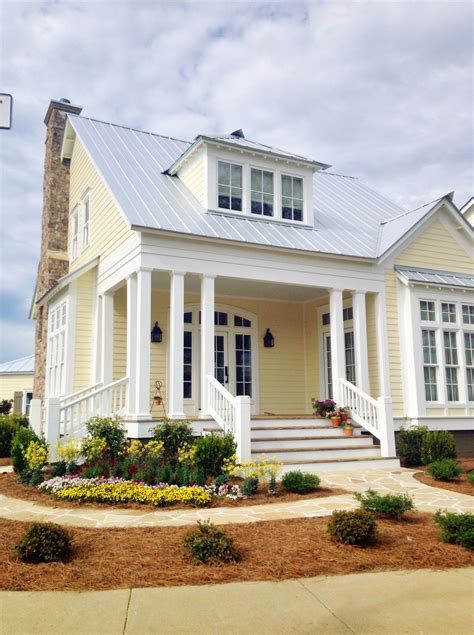 yellow house with metal roof|yellow house with gray roof.